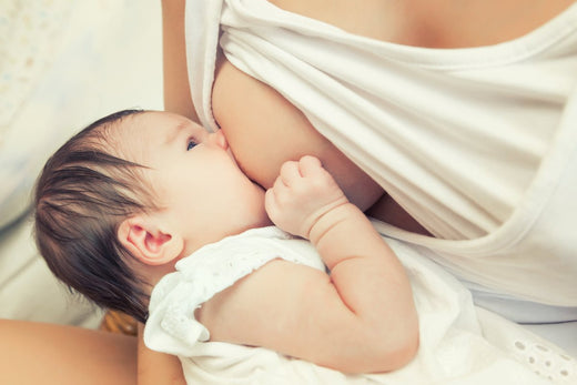 Baby breastfeeding in a laid-back position on the mother's lap