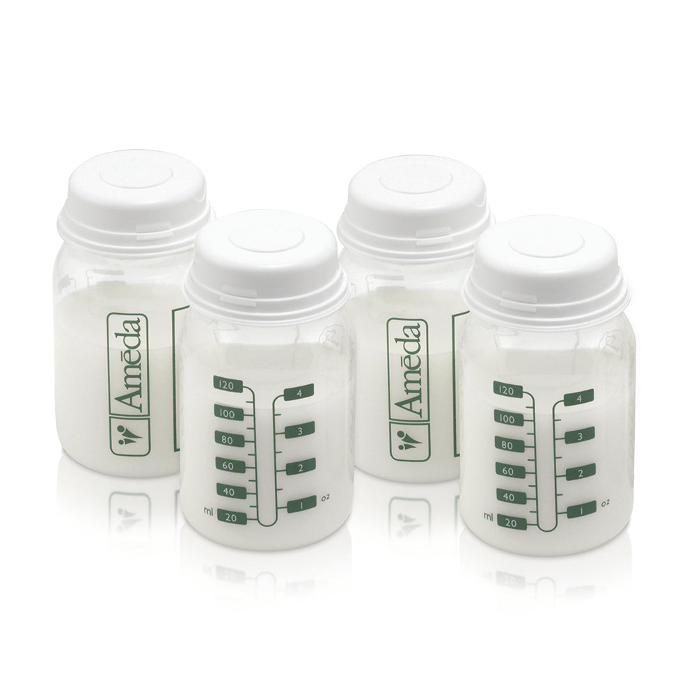 A collection of six small, white, cylindrical containers arranged in two rows. Each container features a label on the front with a logo and several vertical green lines indicating measurements or markings. The containers have a rounded lid. The overall appearance is neat and organized, suggesting they are likely used for storage or dispensing of items.