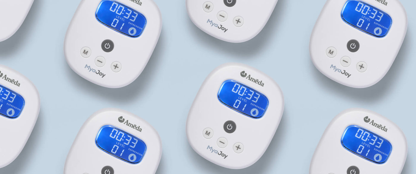 A flat lay image featuring multiple white breast pump control units, labeled "Ameda" and "MyaJoy," on a light blue background. Each unit has a digital display screen showing a timer with "00:33" and a level indicator labeled "LEVEL 01." The control units have buttons for power, expression mode, and level adjustments, arranged in a similar orientation across the image, creating a symmetrical pattern.