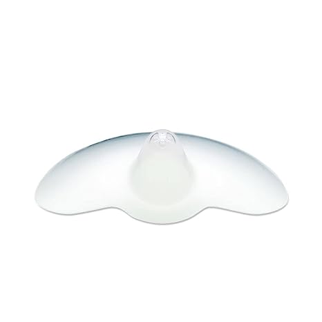 A translucent silicone nipple shield with a rounded central projection and wide, curved edges designed to aid breastfeeding. The shield has a smooth surface and is primarily clear, allowing for light to pass through.