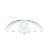 A translucent silicone nipple shield with a rounded central projection and wide, curved edges designed to aid breastfeeding. The shield has a smooth surface and is primarily clear, allowing for light to pass through.