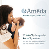 A mother with long dark hair gently kisses her baby's forehead while holding them close. The baby, in a blue outfit with a tiny bow, looks up at her. Soft sunlight filters through a window, creating a warm atmosphere. The Ameda logo and the text "Trusted by hospitals. Loved by moms" appear at the top, with promotional breast pump details. The scene is light and tender.